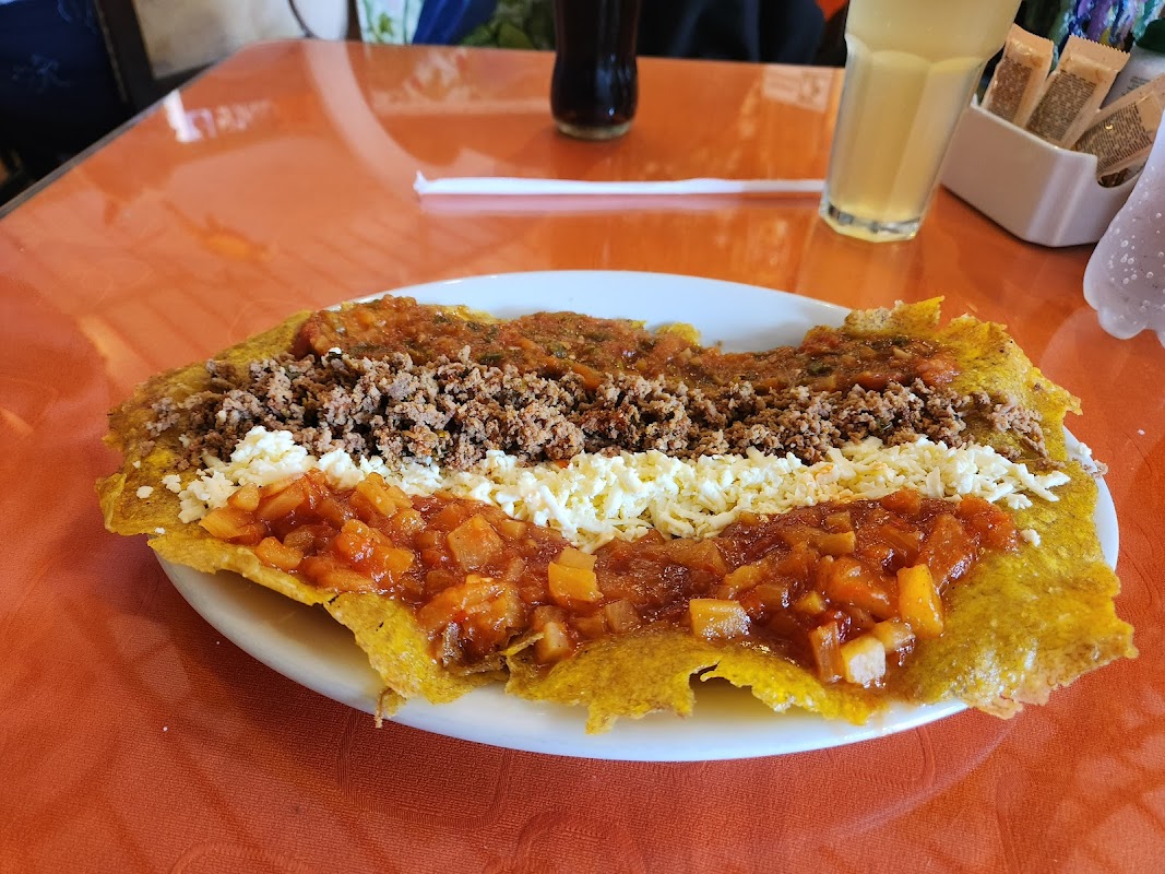Traditional Colombian patacón with ground meat and cheese at a restaurant in Salento, Quindío