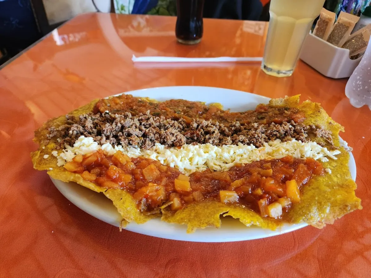 Traditional Colombian patacón with ground meat and cheese at a restaurant in Salento, Quindío