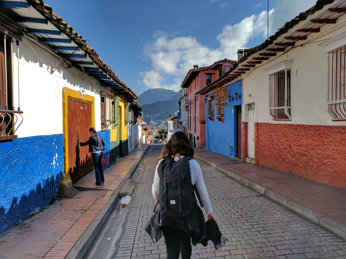 Colonial streets of La Candelaria in Bogotá with colorful buildings and a person walking