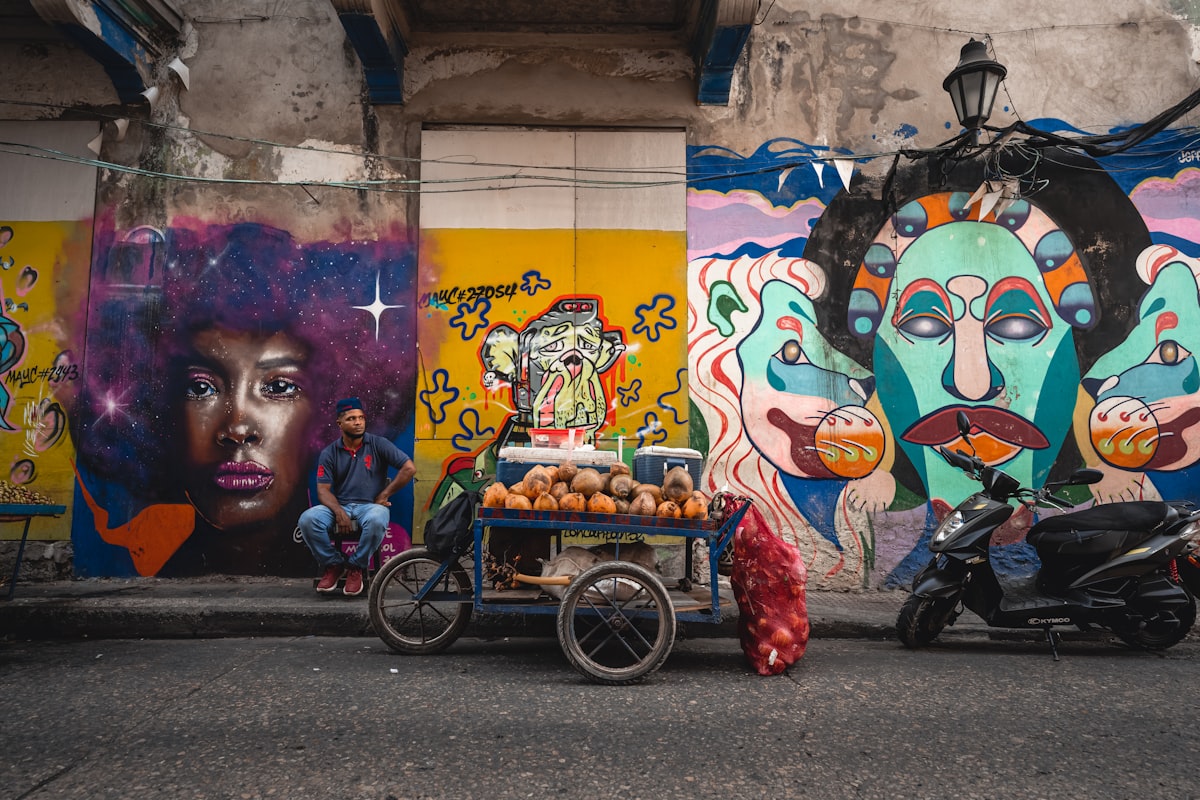 Colorful street scene in Getsemaní, Cartagena with murals and a motorcycle