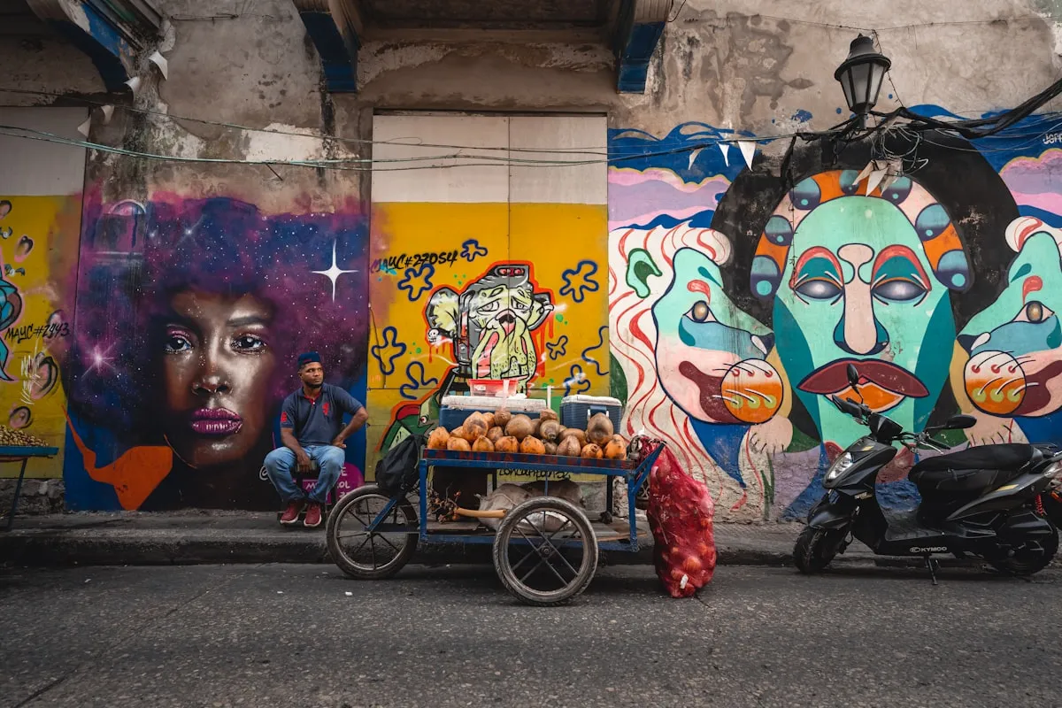 Colorful street scene in Getsemaní, Cartagena with murals and a motorcycle