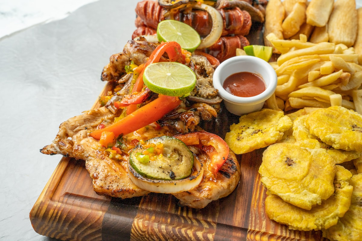 Traditional Colombian food platter with bandeja paisa, rice, beans, and plantain